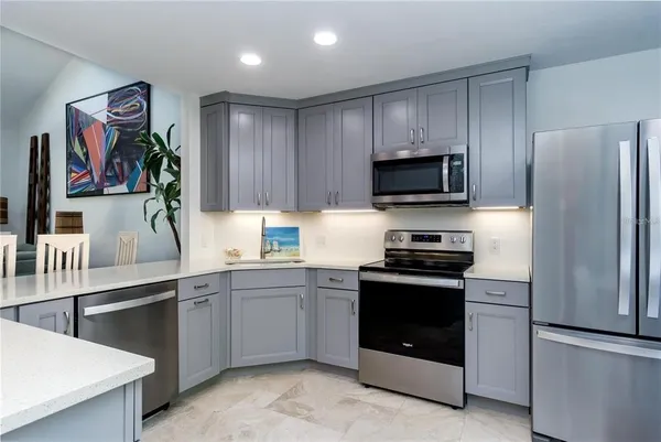 a living room with a large window and furniture