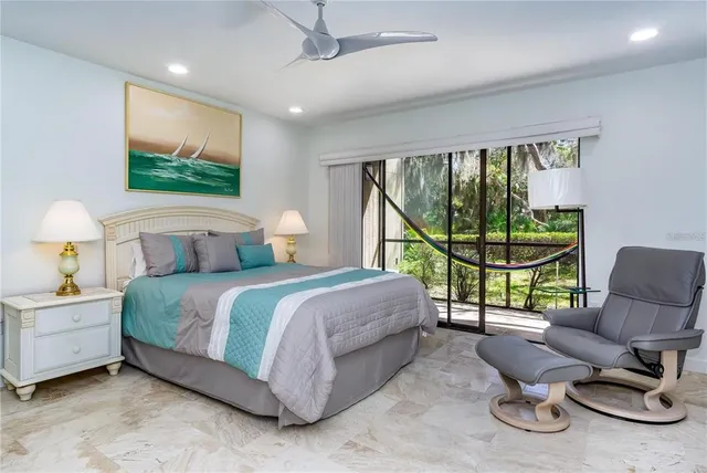 a bedroom with a bed large window with couch