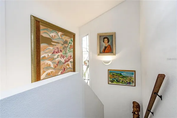 a bedroom with two beds and painting on the wall