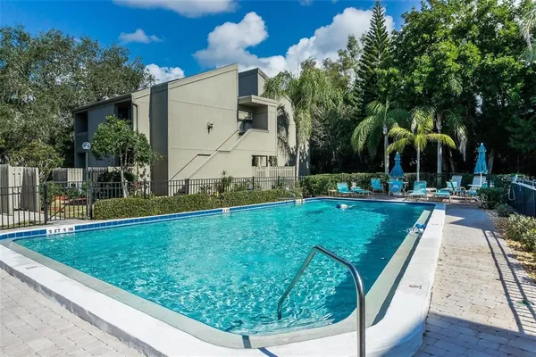 a view of a house with a yard balcony and sitting area