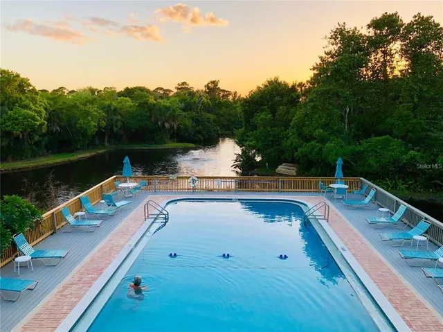 a view of a lake with couches chairs