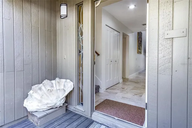 a living room with furniture a flat screen tv and a floor to ceiling window