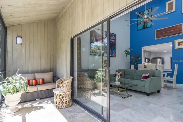 a living room with furniture and a potted plant