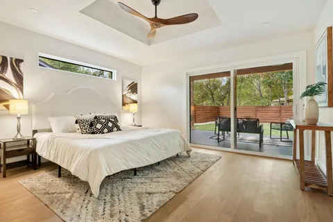 a bedroom with a large bed and a balcony view