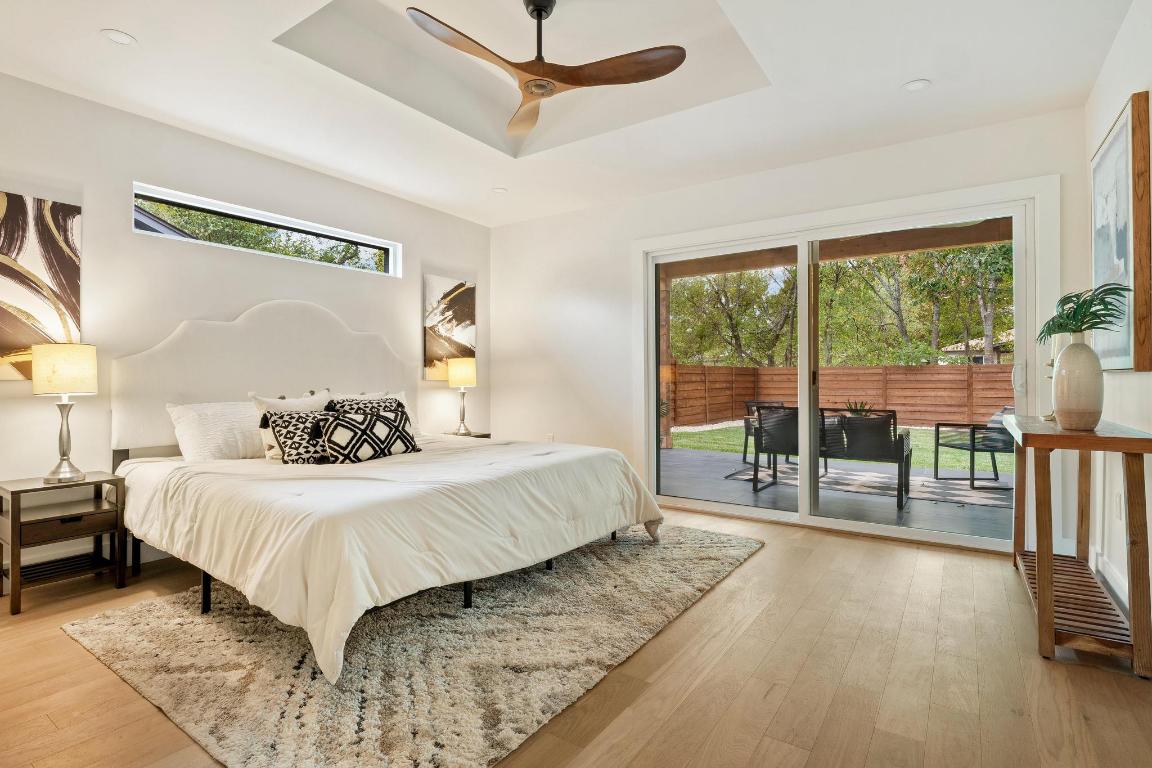 6404 Blarwood Drive Austin, TX 78745 - Photo 11 of 31 a bedroom with a large bed and a balcony view