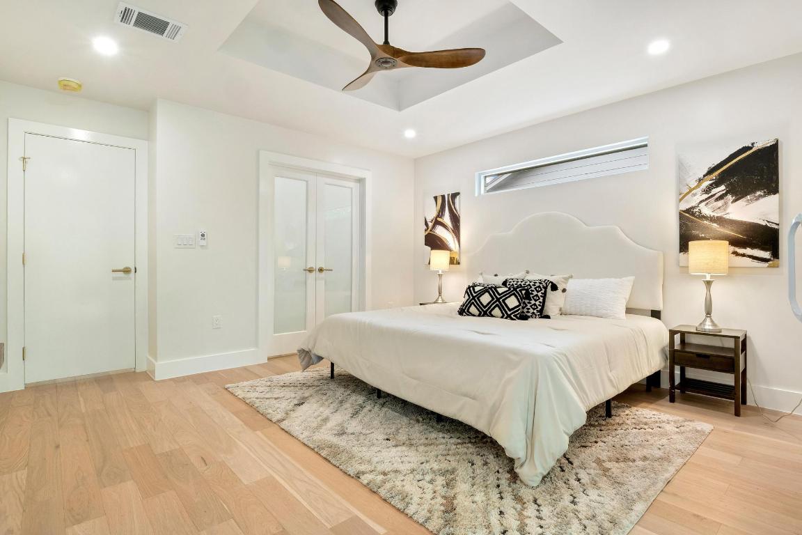 6404 Blarwood Drive Austin, TX 78745 - Photo 12 of 31 a bedroom with a bed and a flat screen tv