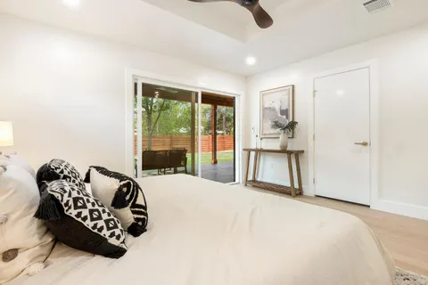 a bedroom with furniture and a large window