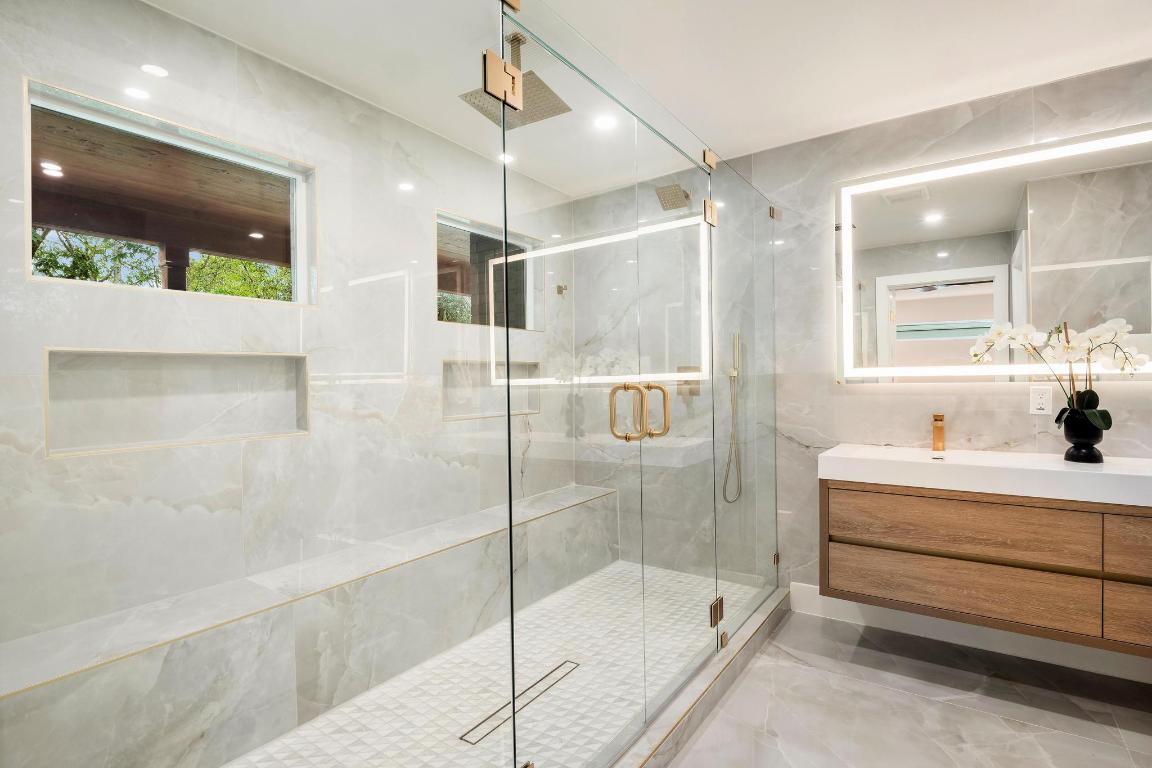 6404 Blarwood Drive Austin, TX 78745 - Photo 14 of 31 a bathroom with a tub sink shower and mirror