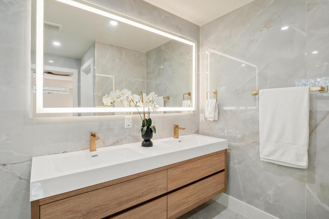6404 Blarwood Drive Austin, TX 78745 - Photo 15 of 31 a bathroom with a sink and a mirror