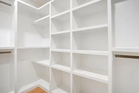 a view of walk in closet with empty racks