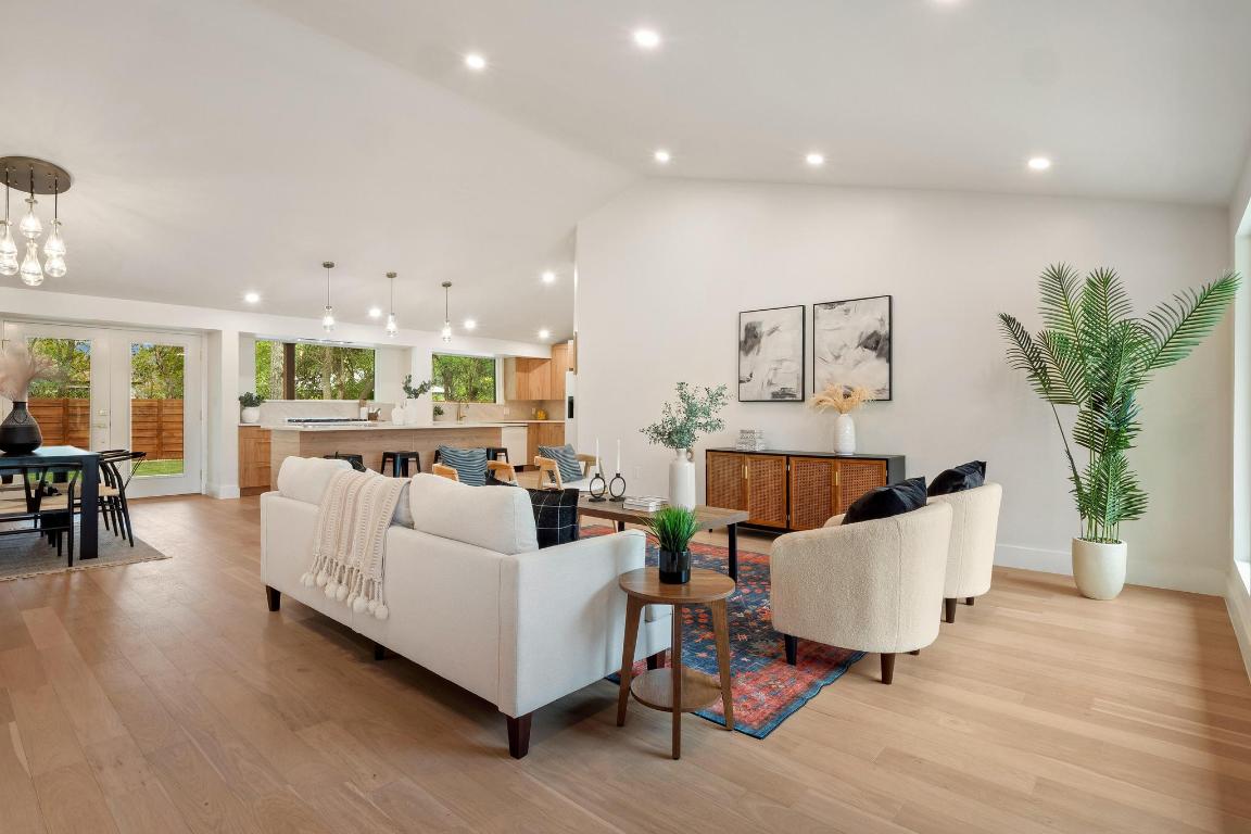6404 Blarwood Drive Austin, TX 78745 - Photo 2 of 31 a living room with furniture and a dining table with wooden floor