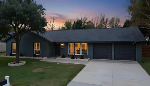 a view of a house with backyard and porch