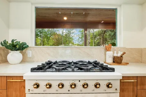 a stove sitting inside of a kitchen with a stove