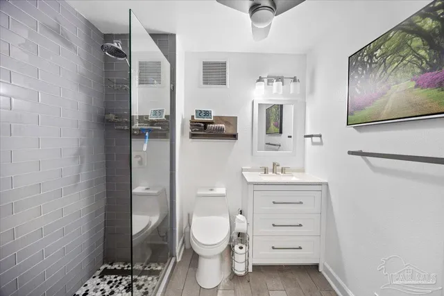 a bathroom with a sink toilet and shower