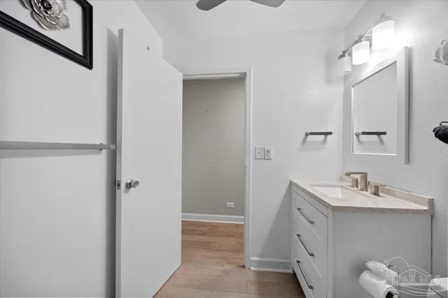 an aerial view of a city with lots of residential buildings ocean and mountain view in back