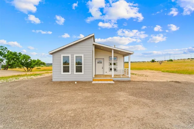 a view of a house with a swimming pool and a yard