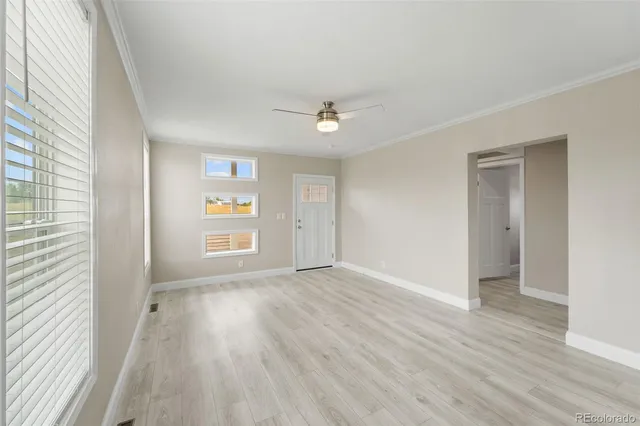 wooden floor in an empty room with a window