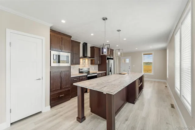 a large kitchen with a table and chairs