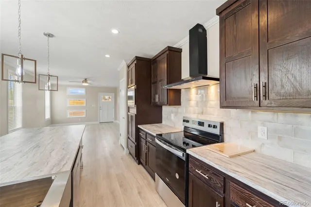 a kitchen with stainless steel appliances granite countertop a sink refrigerator and stove