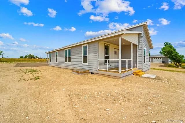 a view of a house with swimming pool and sitting area
