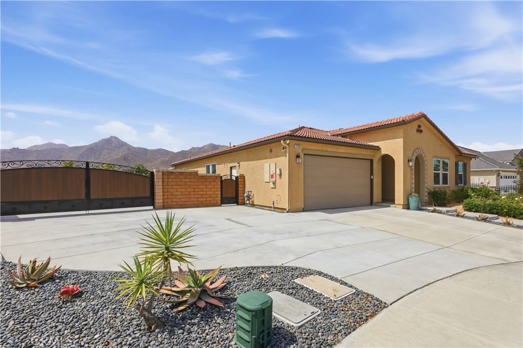 21159 Blue Jeans Court Riverside, CA 92507 - Photo 4 of 63 a front view of a house with a yard and garage