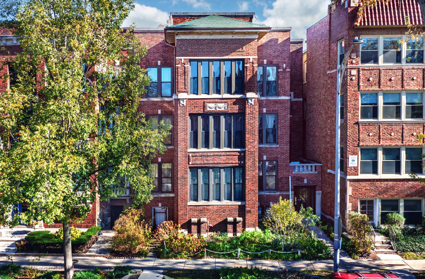front view of brick house with a small yard