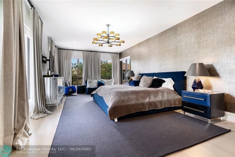 91 Compass Lane Fort Lauderdale, FL 33308 - Photo 17 of 59 a bedroom with a large bed and a chandelier