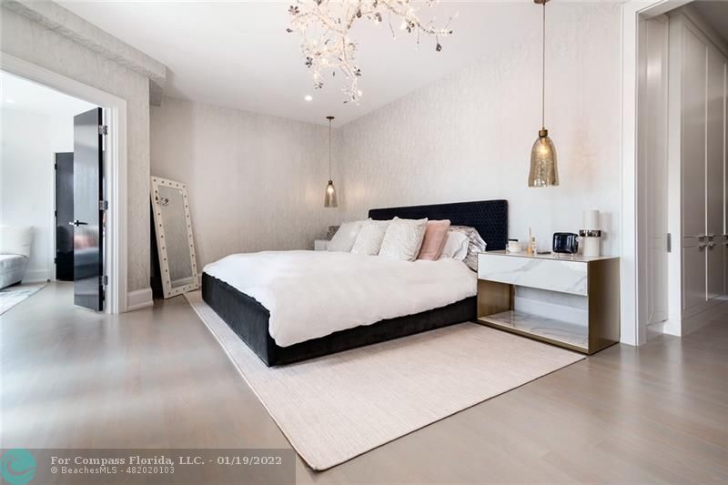 91 Compass Lane Fort Lauderdale, FL 33308 - Photo 18 of 59 a bedroom with a bed and a chandelier
