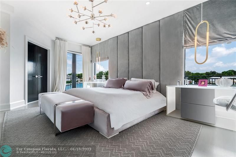91 Compass Lane Fort Lauderdale, FL 33308 - Photo 25 of 59 a bedroom with a large bed and a chandelier