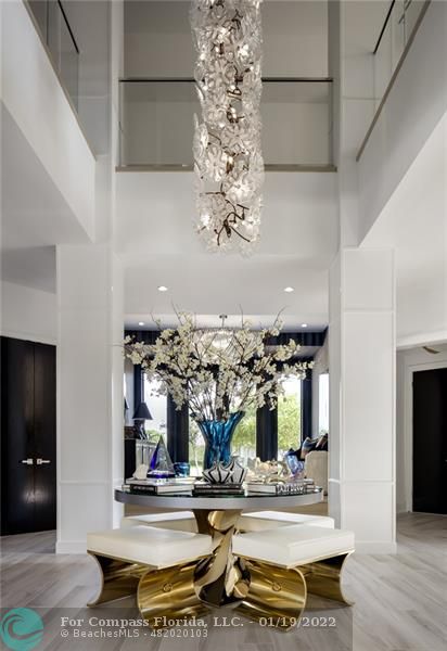 91 Compass Lane Fort Lauderdale, FL 33308 - Photo 43 of 59 a living room with fireplace furniture and chandelier