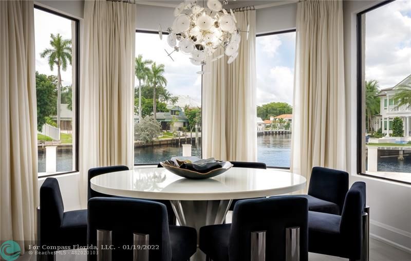 91 Compass Lane Fort Lauderdale, FL 33308 - Photo 50 of 59 a dining room with furniture potted plants and wooden floor