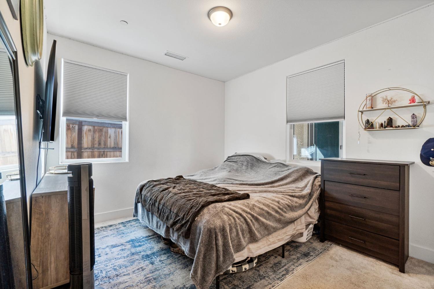 4218 Oak Knoll Road Madera, CA 93636 - Photo 13 of 37 a bedroom with a bed and a closet