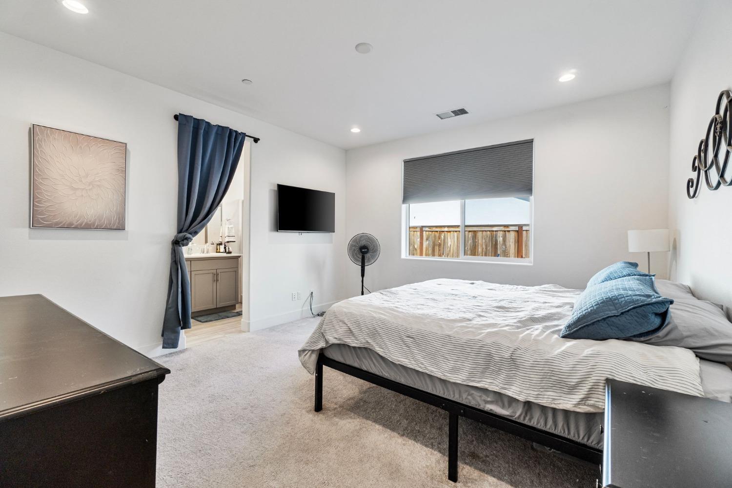4218 Oak Knoll Road Madera, CA 93636 - Photo 16 of 37 a bedroom with a bed and a flat screen tv