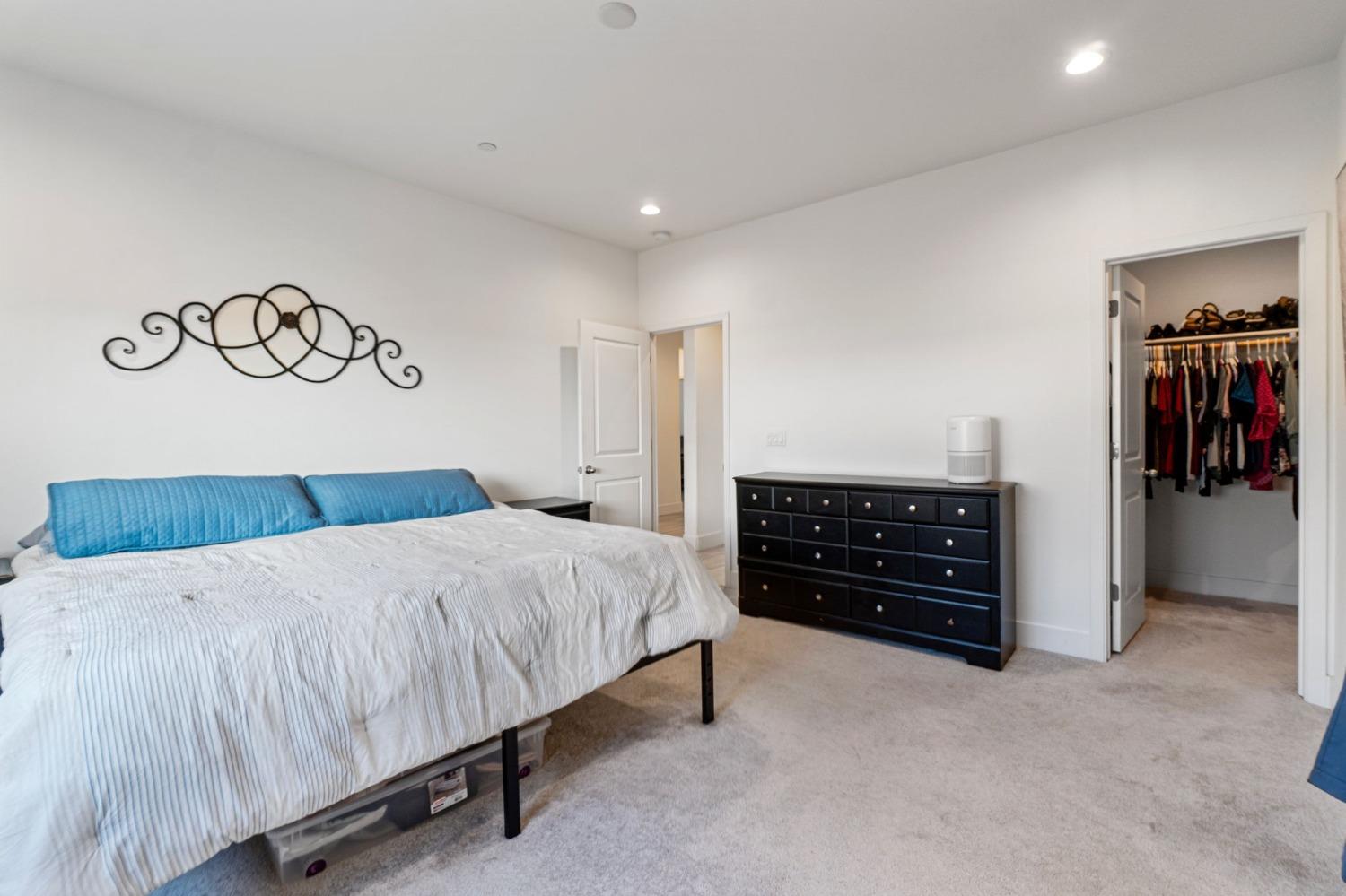 4218 Oak Knoll Road Madera, CA 93636 - Photo 17 of 37 a bedroom with a bed and cabinets