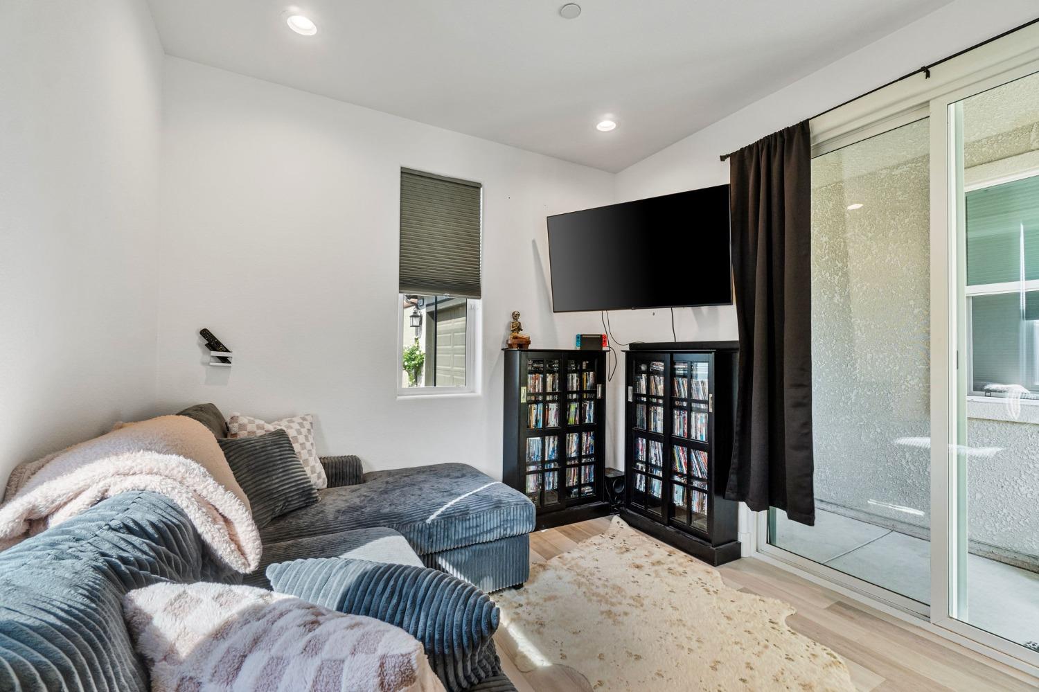 4218 Oak Knoll Road Madera, CA 93636 - Photo 25 of 37 a living room with furniture and a flat screen tv