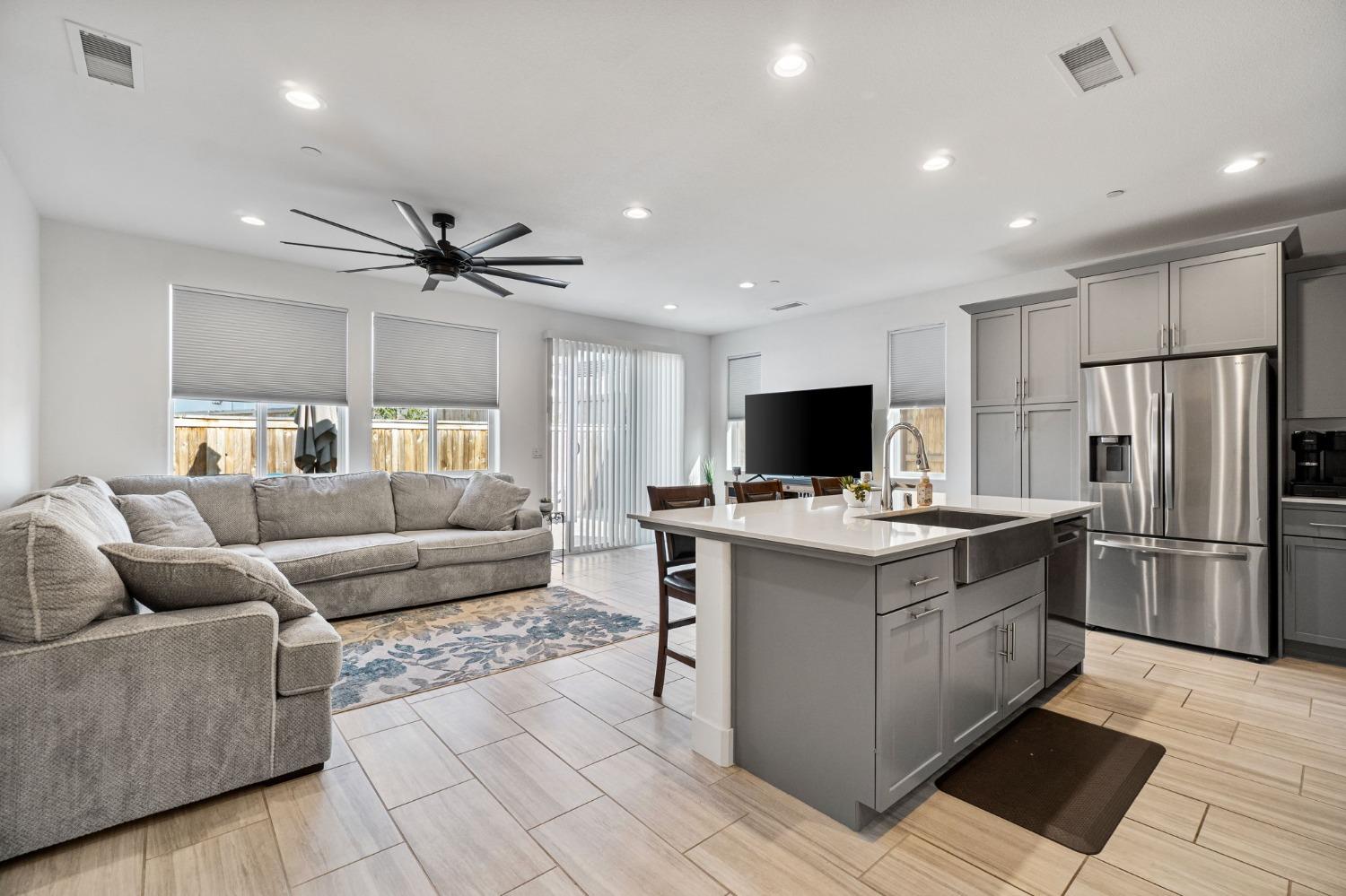4218 Oak Knoll Road Madera, CA 93636 - Photo 5 of 37 a living room with stainless steel appliances kitchen island furniture and a view of kitchen