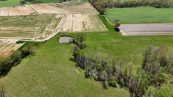 an aerial view of residential houses with outdoor space and river