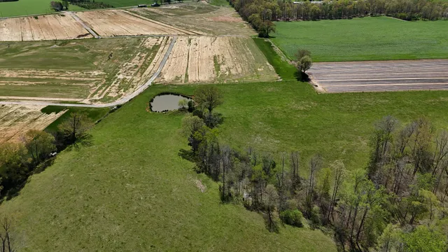 an aerial view of residential houses with outdoor space and river