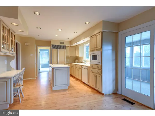 a kitchen with a refrigerator and a sink