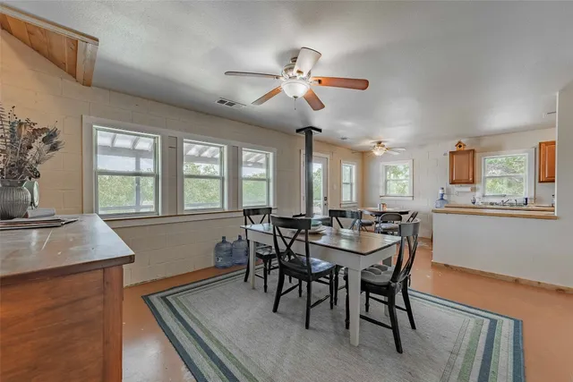 a kitchen with granite countertop a sink and a refrigerator