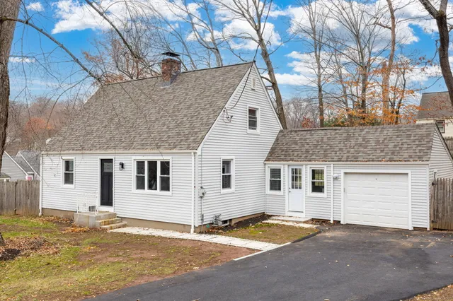 a view of a house with snow on the road