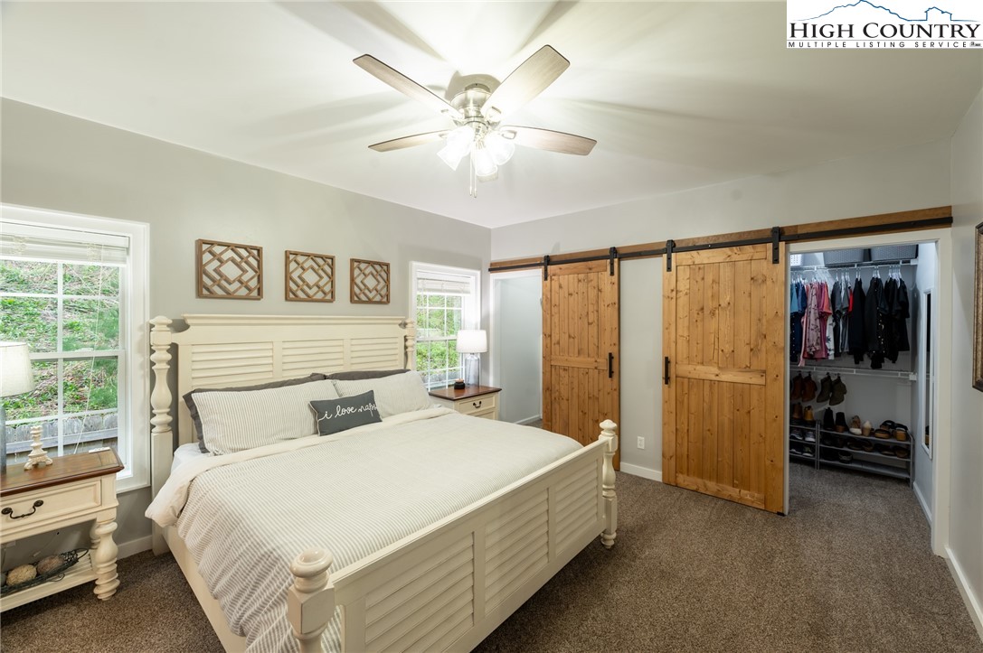 202 Herman Lane Boone, NC 28607 - Photo 23 of 45 a bedroom with a bed and a large window