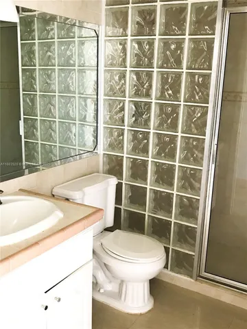 a bathroom with a toilet a sink and a shower