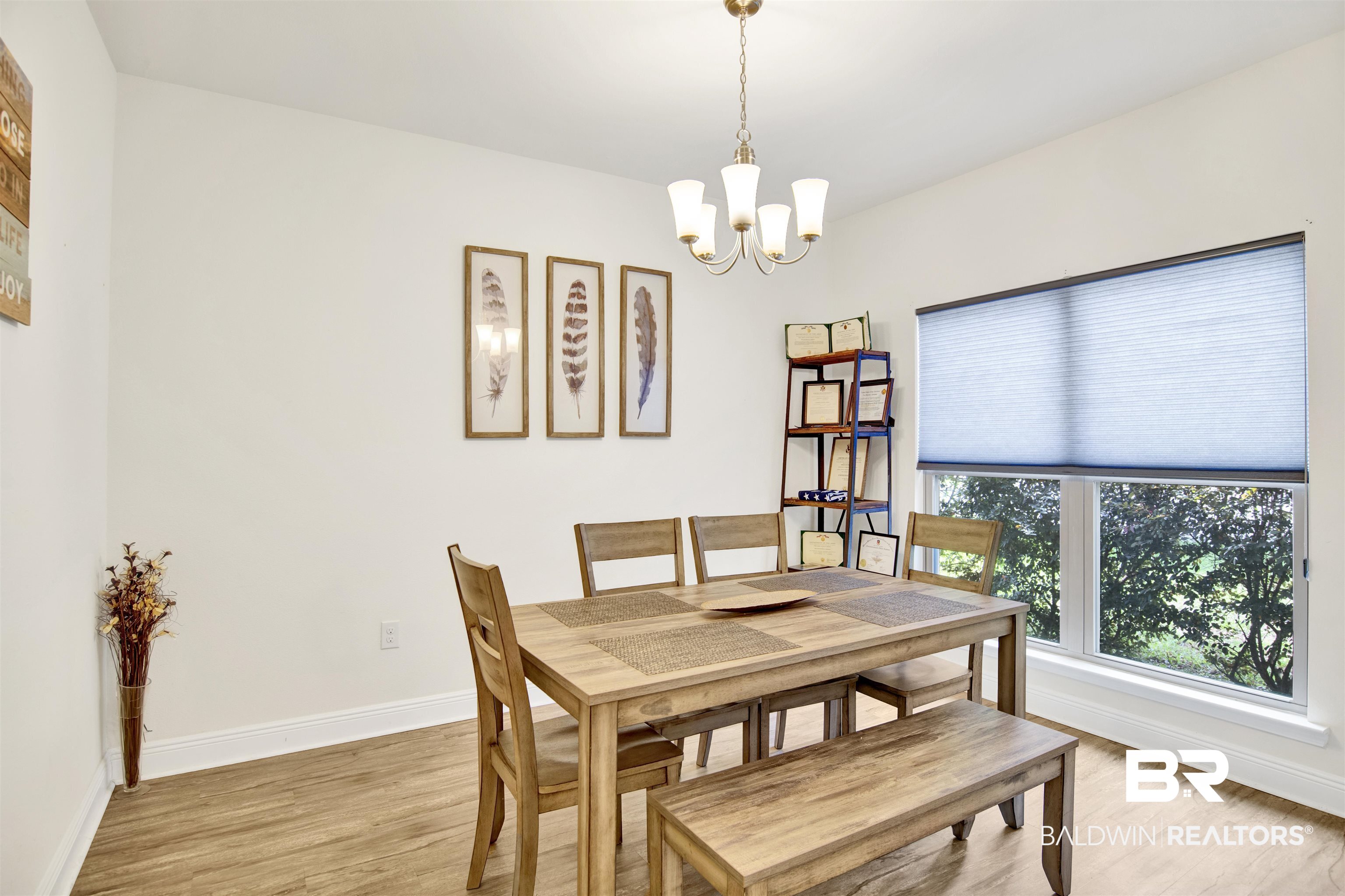 1468 Surrey Loop Foley, AL 36535 - Photo 5 of 28 Dining room featuring a chandelier, light wood-style flooring, and baseboards