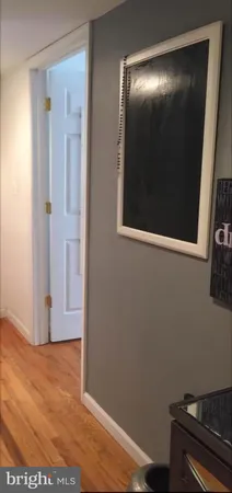 a view of a room with wooden floor and a window