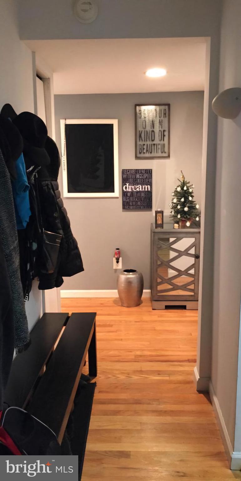1101 St Paul Street, Unit 302 Baltimore, MD 21202 - Photo 7 of 37 a view of a living room with furniture and a flat screen tv