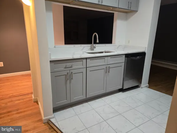 a kitchen with stainless steel appliances white cabinets a stove and a microwave