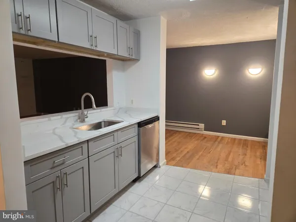 a kitchen with a refrigerator sink and cabinets