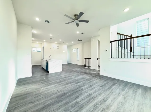 a kitchen with stainless steel appliances white cabinets a refrigerator and a stove