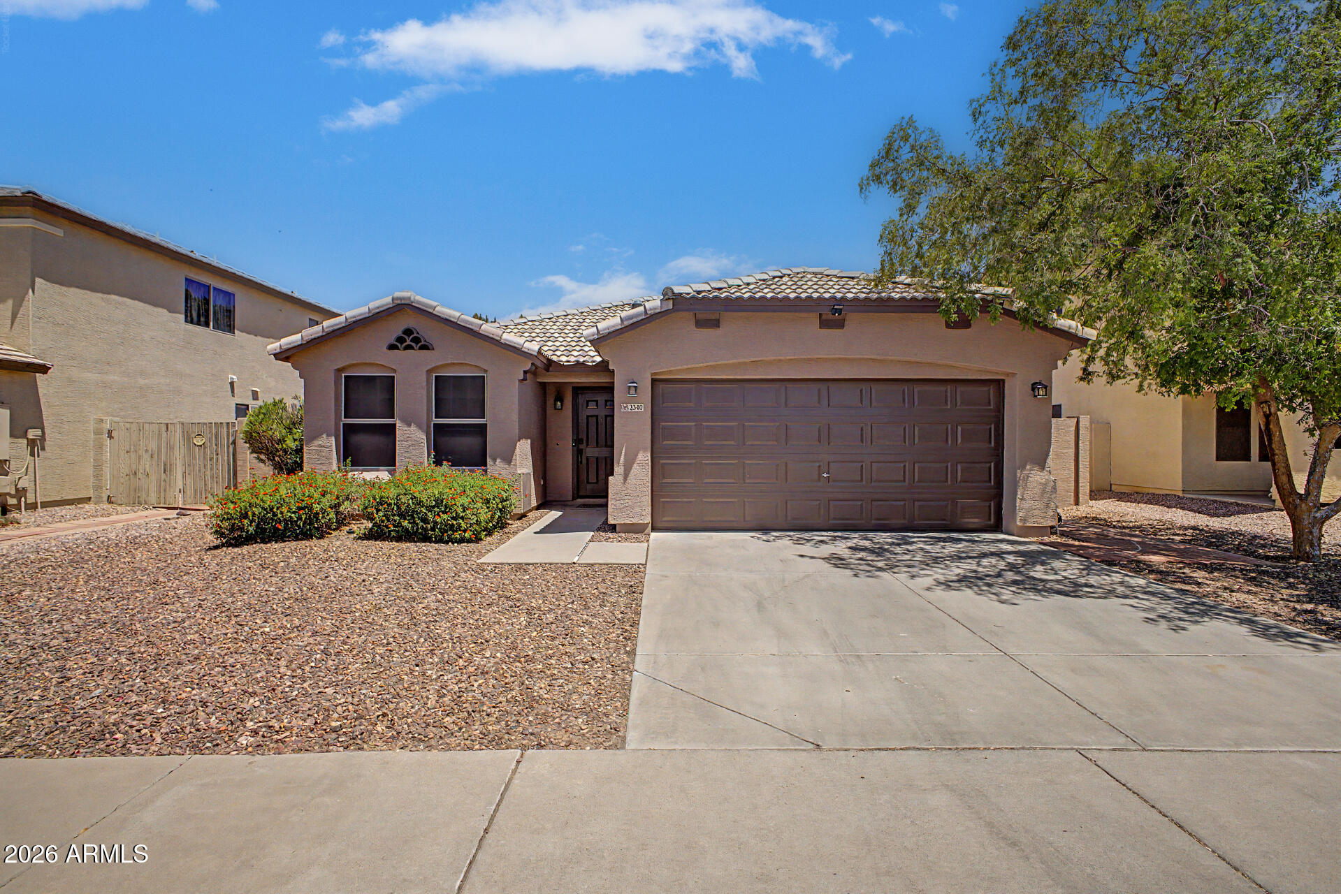2340 West Apollo Road Phoenix, AZ 85041 - Photo 1 of 26 a front view of a house with a garden